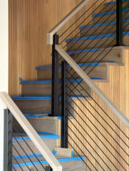 Rod railing with wood top rail transitions