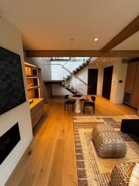 Living room with floating stair beyond