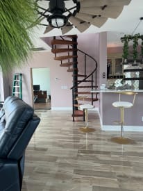 Spiral stair with cable railing in open kitchen