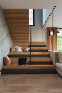 A warm oak Stack stair with built-in seating steps and slender black vertical rods beside a pendant-lit window.