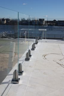 Waterfront glass railing on stainless spigots