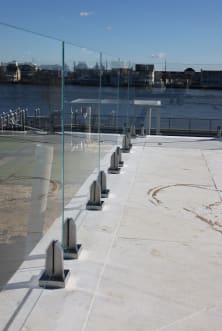 Waterfront glass railing on stainless spigots