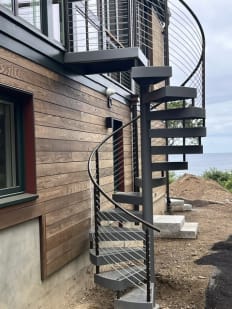 Metal spiral stair with cable railing