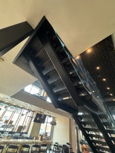 Commercial steel stair with glass railing