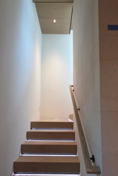 Straight run of oak treads with LED strip lighting and a wood wall handrail