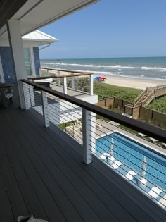 Cable railing balcony over pool and beach