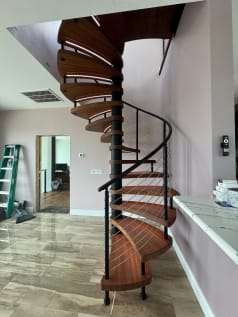 Wood spiral stair with cable railing