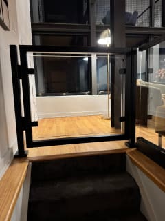 Framed glass gate at stair top