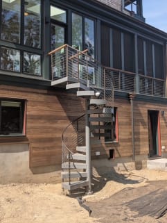 Spiral stair to balcony with cable railing