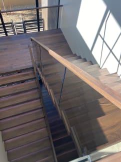 Walnut switchback with glass and wood handrail