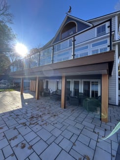 Lake house deck with glass railing