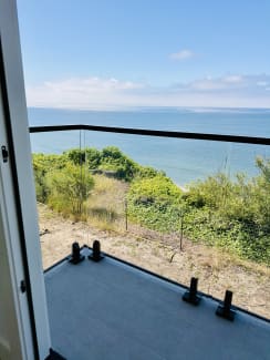 Glass balcony railing overlooking the ocean