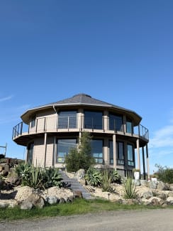 Cable railing on round hilltop home