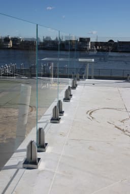 Waterfront glass railing on stainless spigots