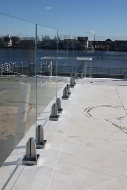Waterfront glass railing on stainless spigots