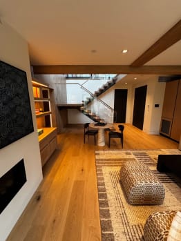 Living room with floating stair beyond