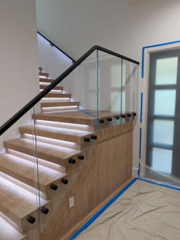 Standoff glass railing on lit replacement treads