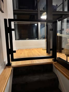 Framed glass gate at stair top