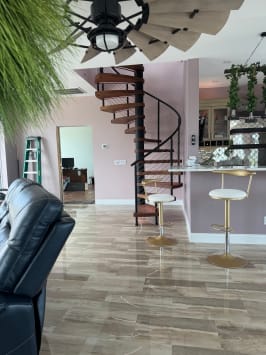 Spiral stair with cable railing in open kitchen
