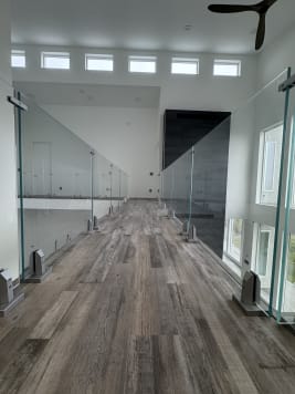Two runs of frameless glass on talon spigots line an elevated walkway