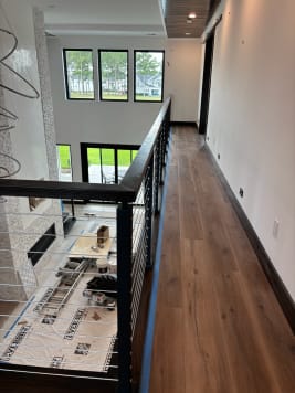 Black cable railing with dark wood handrail