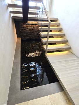 Glowing LED floating landing and treads hover above a dark indoor pool