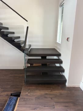 Dark floating stair with glass