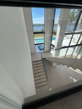 Floating stair with glass guard overlooking pool