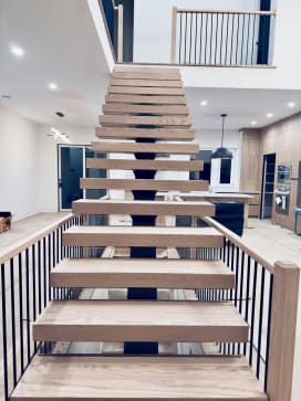 Head-on view of a straight white oak FLIGHT Mono stair rising to a loft