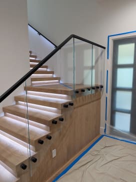 Standoff glass railing on lit replacement treads