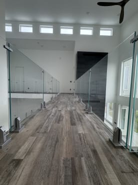 Two runs of frameless glass on talon spigots line an elevated walkway