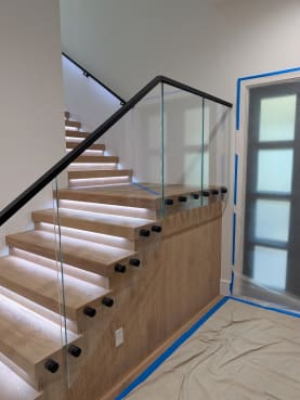 Standoff glass railing on lit replacement treads