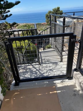 Black railing gate at deck stair