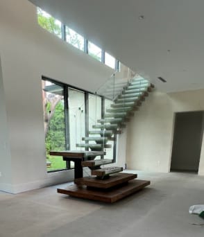 Mono stair with plinths and glass railing