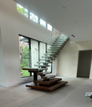 Mono stair with plinths and glass railing