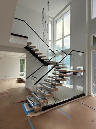 Glass railing with black top cap