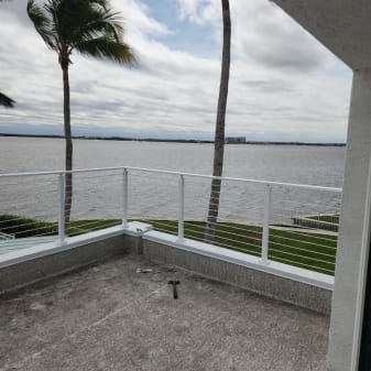 White rod railing on waterfront rooftop
