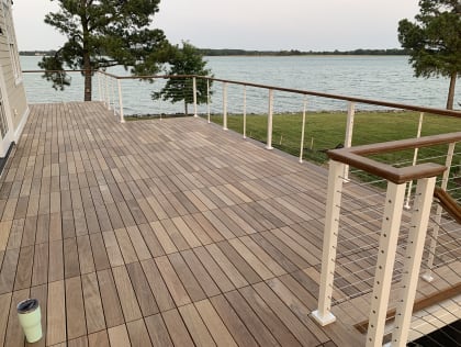 Waterfront deck with white cable railing