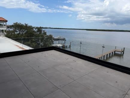 Rooftop glass railing over waterfront