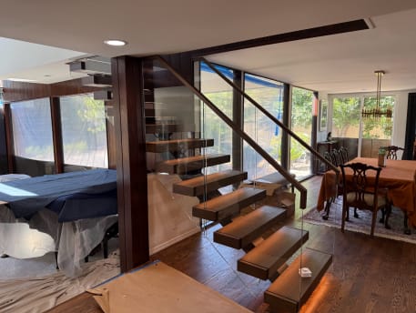 Floating stair with glass railing and LED lighting