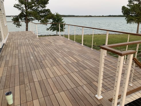 Waterfront deck with white cable railing