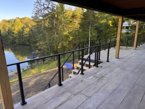 Covered lakeside deck with cable railing