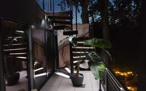 Exterior spiral stair with LED treads at night