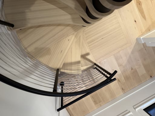 Looking down a spiral stair with cable railing