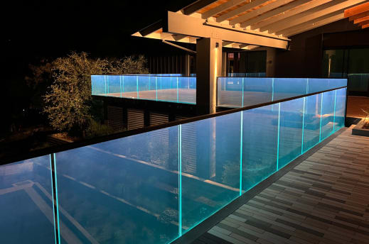Glass railing with LED top cap at night