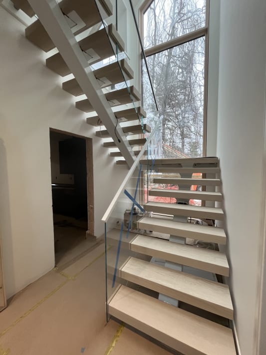 White oak floating stair with glass