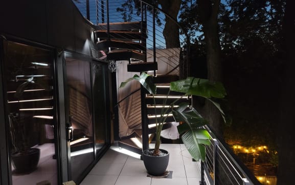 Exterior spiral stair with LED treads at night