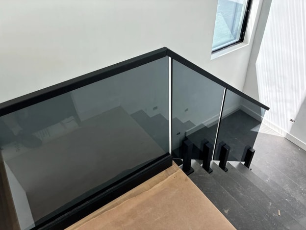 Tinted glass stair guard with black cap